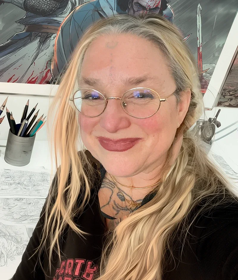 Close-up portrait of Juliana Loomer with glasses, in front of comic book artwork